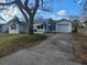 White house with a garage and striped awnings at 469 80Th Way, St Pete Beach, FL 33706