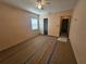 Bright bedroom with vinyl flooring, window with blinds, ceiling fan and closet at 469 80Th Way, St Pete Beach, FL 33706