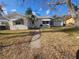 Single-story home with attached garage, mature trees, and a walkway at 469 80Th Way, St Pete Beach, FL 33706