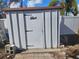 White metal storage shed with a brown roof at 469 80Th Way, St Pete Beach, FL 33706