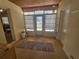 Sunroom with door leading to backyard, tiled floor, and window blinds at 469 80Th Way, St Pete Beach, FL 33706