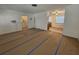 Living room with view into kitchen, vinyl flooring, and access to other rooms at 469 80Th Way, St Pete Beach, FL 33706