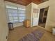 Sunroom features wood cabinets, tiled floor, and access to kitchen at 469 80Th Way, St Pete Beach, FL 33706