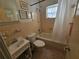 Clean bathroom with tub, shower, toilet, and vanity at 469 80Th Way, St Pete Beach, FL 33706