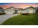 Home exterior at dusk with a two-car garage and manicured lawn at 101 Brookover Ln, Brandon, FL 33511