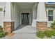 Elegant front entry with stone accents and a dark-stained door at 101 Brookover Ln, Brandon, FL 33511