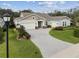 House exterior featuring a two-car garage and landscaped yard at 101 Brookover Ln, Brandon, FL 33511