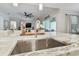 Modern kitchen island with a large sink, granite countertop and a stylish faucet at 101 Brookover Ln, Brandon, FL 33511