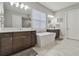 Elegant bathroom with double vanity and soaking tub at 101 Brookover Ln, Brandon, FL 33511