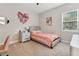 Cozy bedroom with light pink bedding and window at 101 Brookover Ln, Brandon, FL 33511