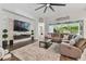Relaxing living room featuring a sectional sofa, coffee table, and built-in entertainment center at 101 Brookover Ln, Brandon, FL 33511