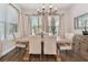 Bright dining room featuring a rustic wood table, neutral chairs, and large windows at 101 Brookover Ln, Brandon, FL 33511