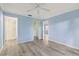 Spacious bedroom with wood-look floors and ensuite bathroom at 3832 Lanyard Ct, New Port Richey, FL 34652