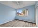 Bedroom with light blue walls and wood-look floors at 3832 Lanyard Ct, New Port Richey, FL 34652