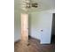Simple bedroom with wood-look floors and ceiling fan at 10642 Shalimar St, New Port Richey, FL 34654