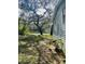 Backyard with large oak tree and grass at 10642 Shalimar St, New Port Richey, FL 34654