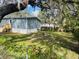Side yard with grass, and chain link fence at 10642 Shalimar St, New Port Richey, FL 34654