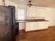 White cabinets, black appliances, and laminate floors at 10642 Shalimar St, New Port Richey, FL 34654