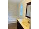 Bathroom with tub, vanity, and updated tile at 10642 Shalimar St, New Port Richey, FL 34654
