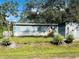 Blue mobile home with a detached shed and fenced yard at 10642 Shalimar St, New Port Richey, FL 34654