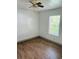 Bedroom with wood-look floors and ceiling fan at 10642 Shalimar St, New Port Richey, FL 34654