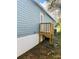 Blue mobile home with wooden steps and a fenced yard at 10642 Shalimar St, New Port Richey, FL 34654