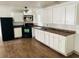 Bright kitchen with white cabinets and laminate flooring at 10642 Shalimar St, New Port Richey, FL 34654