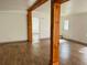 Living area with wood-look floors and exposed beams at 10642 Shalimar St, New Port Richey, FL 34654
