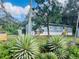 Ranch-style home with light blue siding, nestled in greenery at 10642 Shalimar St, New Port Richey, FL 34654