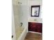 Bathroom with tub, vanity, and wood cabinet at 10642 Shalimar St, New Port Richey, FL 34654