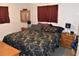 Main bedroom with large bed, nightstands, and ample closet space at 1420 10Th E Ave, Palmetto, FL 34221