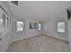 Neutral-toned bedroom with carpeted floors, ample natural light, and a spacious closet at 1529 Allegheny Dr, Sun City Center, FL 33573