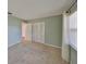 This bedroom features neutral carpet, a large closet, and a window providing natural light at 1529 Allegheny Dr, Sun City Center, FL 33573