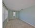Bedroom with blue walls, plush carpet, and a window that brings in natural light at 1529 Allegheny Dr, Sun City Center, FL 33573