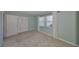 Bedroom showcasing light blue walls, plush carpet, and ample natural light at 1529 Allegheny Dr, Sun City Center, FL 33573