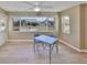 Bright dining area featuring neutral walls, ceiling fan, and a large window offering backyard views at 1529 Allegheny Dr, Sun City Center, FL 33573