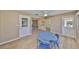 Open dining room featuring wood-look floors and a connecting doorway to the kitchen at 1529 Allegheny Dr, Sun City Center, FL 33573