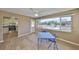 Well-lit dining area featuring wood-look flooring, a ceiling fan, and scenic backyard views at 1529 Allegheny Dr, Sun City Center, FL 33573