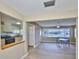 Open concept dining room with a ceiling fan and bright natural light from the large windows at 1529 Allegheny Dr, Sun City Center, FL 33573