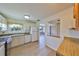 Bright kitchen featuring white cabinetry, modern appliances, and a pass-through to the dining area at 1529 Allegheny Dr, Sun City Center, FL 33573