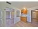 Kitchen area showcasing wood cabinets and modern appliances, seamlessly connecting to the dining and living spaces at 1529 Allegheny Dr, Sun City Center, FL 33573