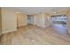 Spacious living room featuring modern wood-look flooring and neutral paint, creating a bright and inviting atmosphere at 1529 Allegheny Dr, Sun City Center, FL 33573