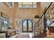 Spacious foyer with ornate ironwork on stairs and doors, plus unique architectural details at 1679 Sea Breeze Dr, Tarpon Springs, FL 34689