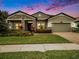 Two-story house with stone accents and landscaped lawn at 1741 Cherry Walk Rd, Lutz, FL 33558