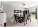 Elegant dining room with a table and chairs and access to the backyard at 1911 Fan Aloe Way, Ruskin, FL 33570