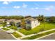 Two-story house with gray exterior, situated on a corner lot at 1911 Fan Aloe Way, Ruskin, FL 33570