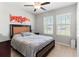 Bright bedroom with a queen-size bed and large windows at 1911 Fan Aloe Way, Ruskin, FL 33570