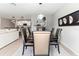 Bright dining room with modern light fixtures and hardwood floors at 1911 Fan Aloe Way, Ruskin, FL 33570