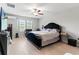 Main bedroom with a king-size bed and sitting area at 1911 Fan Aloe Way, Ruskin, FL 33570