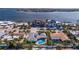 Aerial view of a house with a pool, located in a waterfront neighborhood with other houses and boats at 2010 E Vina Del Mar Blvd, St Pete Beach, FL 33706